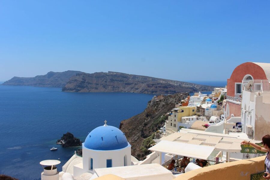 1-Day Boat Trip: Santorini Volcano, Thirassia & Oia Sunset - Returning by sea beneath Oia cliffs: the best photo angle comes late