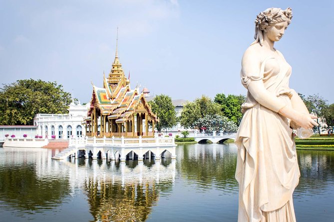 Ayutthaya Sunset Tour: Iconic Temples & Scenic River Boat Ride - Wat Mahathat: the Buddha head in tree roots