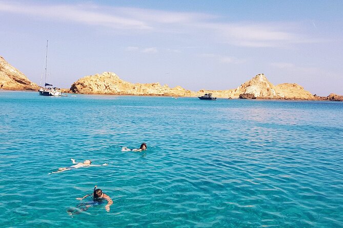 Boat trip through the coves of northern Menorca from Fornells - Virgin coves, limestone water, and Cala Rotja’s red-clay story