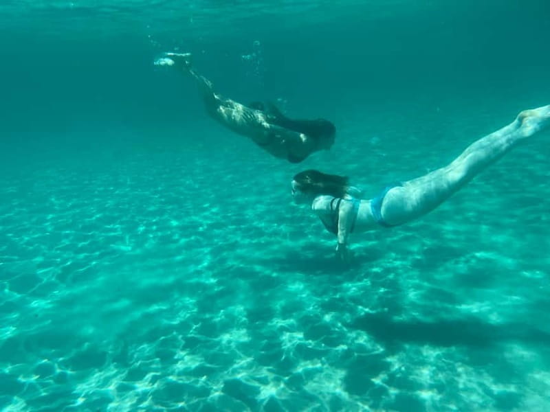 Cagliari: Boat Tour with 4 Swim Stops, Snorkeling & Prosecco - Cala Bernat: a classic swim-photo mix
