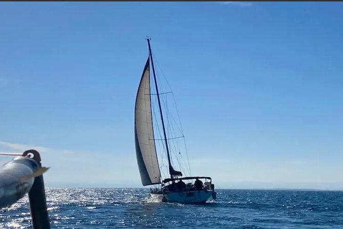 Catania boat tour along the coast with aperitif and snorkeling - Stop 1: Aci Castello—lava-rock coast, seen the fun way