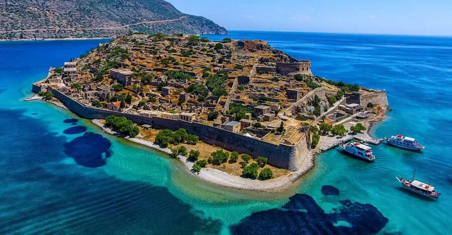 Crete: Spinalonga, Elounda, & Agios Nikolaos Boat Tour & BBQ - Arriving at Spinalonga: the story starts before you even step off