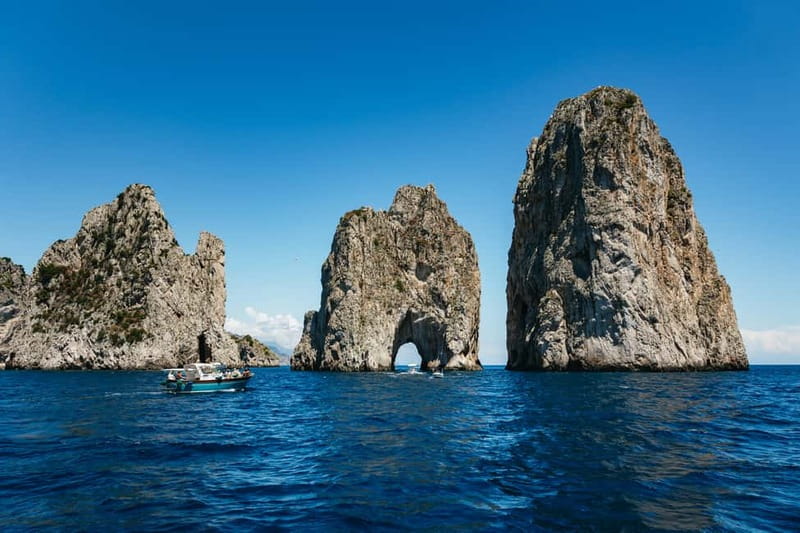 From Sorrento: Capri Boat Tour with Blue Grotto Visit - The Boat Cruise Stops: Faraglioni, Punta Carena, and Quick Grotto Photo Moments
