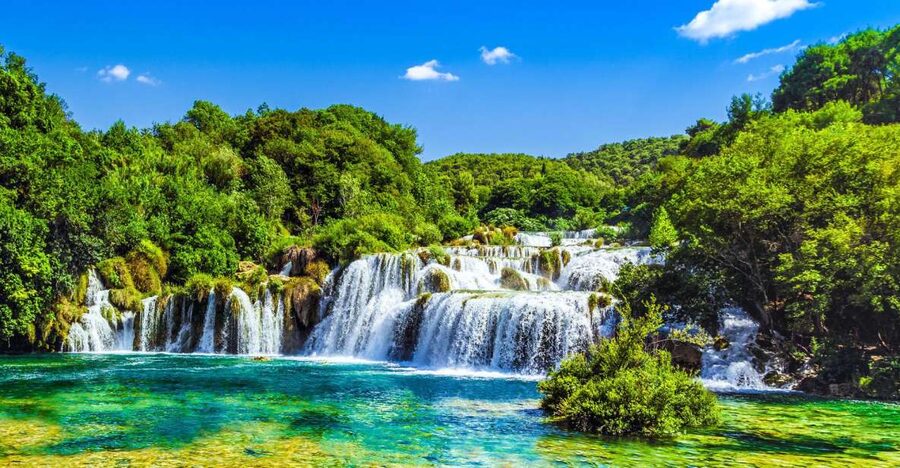 From Split & Trogir: Krka Waterfalls Day Tour with Boat Ride - Down to the riverboat: scenic views and a break from legs