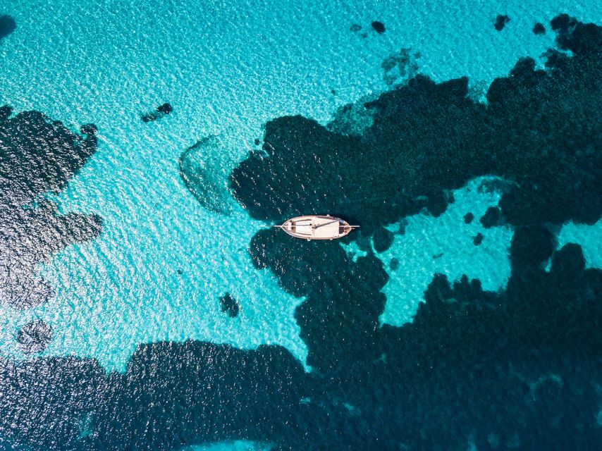 From Stintino: Asinara Vintage Sailing Boat Tour with Lunch - Cala Reale: quarantine walls, the Roman ship find, and donkeys