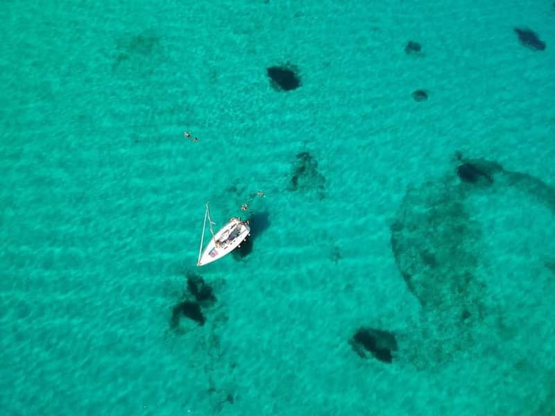 From Stintino: Half-Day Sailing Boat Tour to La Pelosa - On a sailing boat: shade, seating, and a group of eight