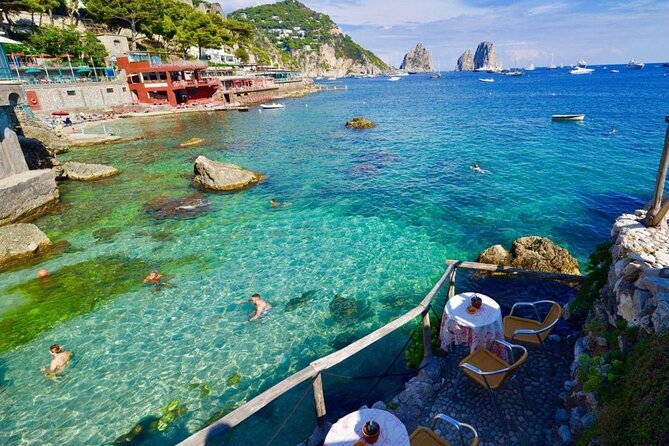 Full Day Private Boat Tour to Capri from Positano - Capri shoreline stops: beaches, Roman bathing history, and quick photo windows