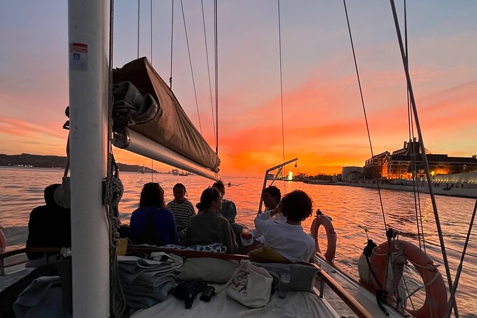 Lisbon Sunset Boat Cruise Tour With Drinks Included - Christ the King and the Almada side: the sunset contrast