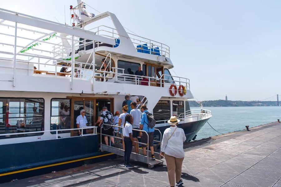 Lisbon: Tagus River Boat Tour with One Drink Included - On board comfort: sundeck seats and the blanket reality