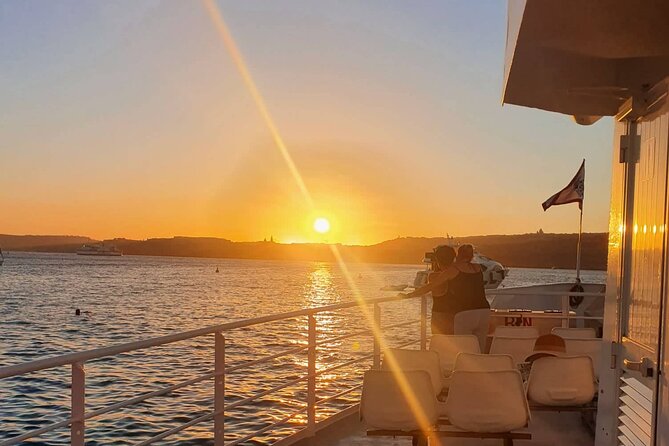 Malta Sunset Boat Tour: Bugibba to Comino Blue Lagoon Cruise - Onboard perks: bar, food, and the 10-meter slide