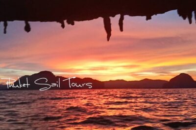 Phuket Sunset Big Boat Trip To Phang Nga Bay & James Bond Island - Canoeing through sea caves: your feet, your splash zone, and the paddle man