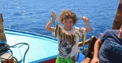 Rhodes Town: Fishing Boat Trip with Fish Meal and Swim Stops - The boat experience: seating, comfort, and time on the water