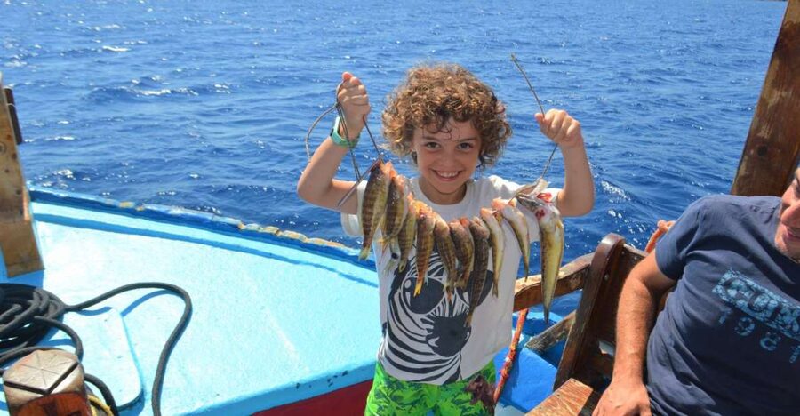 Rhodes Town: Fishing Boat Trip with Fish Meal and Swim Stops - The boat experience: seating, comfort, and time on the water