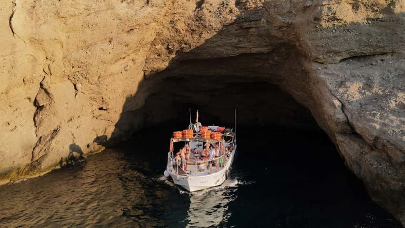 San Antonio: Cala Bassa, Cala Conta and Cave Boat Trip - Sailing toward southern Ibiza cliffs and caves