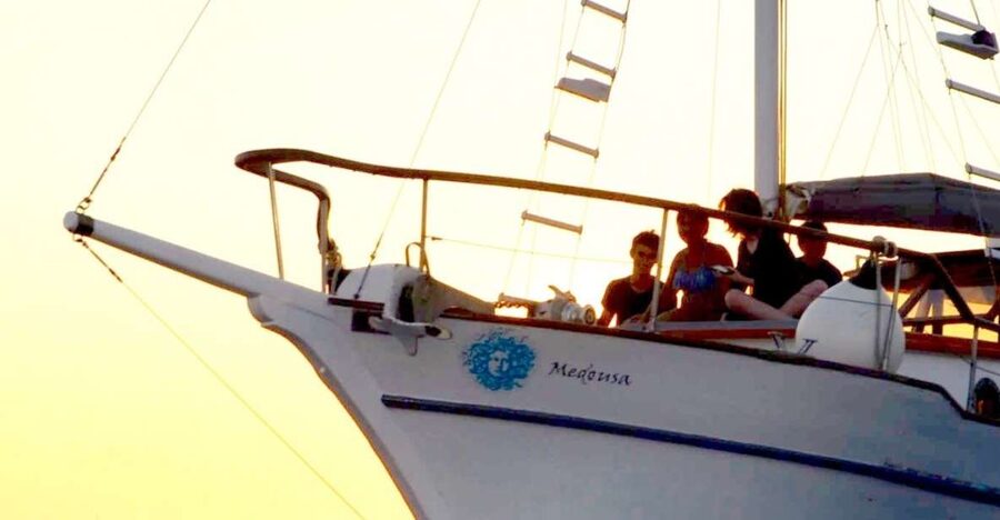 Santorini: Traditional Wooden Boat Tour with Meal and Wine - Black Mountain snorkeling and the volcanic hot springs swim