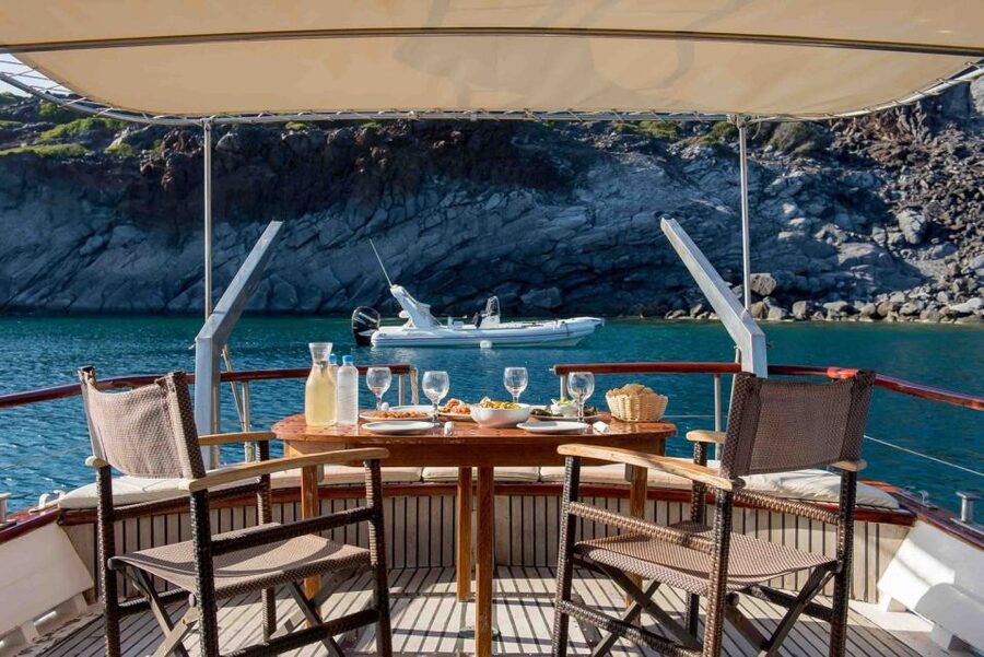 Santorini: Traditional Wooden Boat Tour with Meal and Wine - Ammoudi finish, Agios Nikolaus pit stop, and how the sunset option changes everything