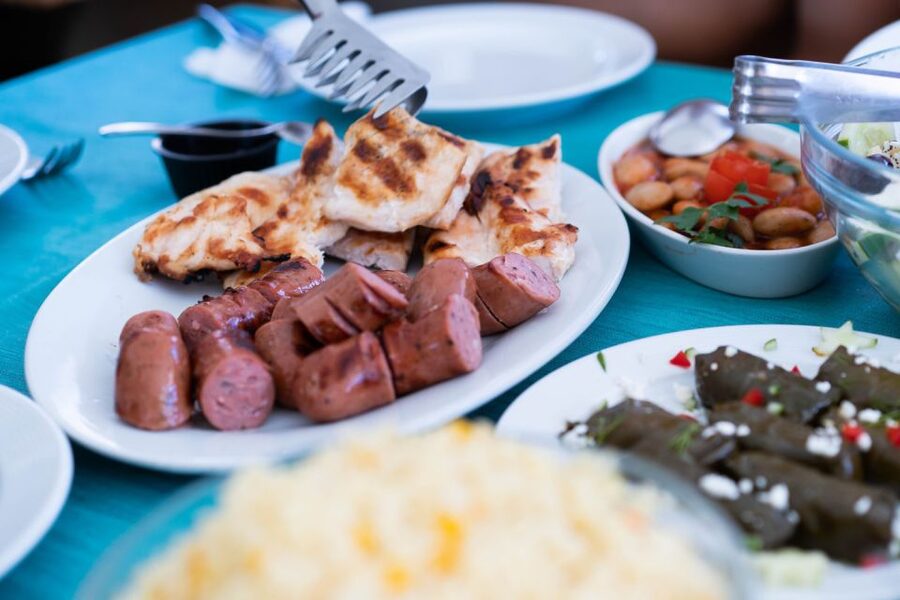 Santorini: Traditional Wooden Boat Tour with Meal and Wine - Small-group sailing with real crew energy