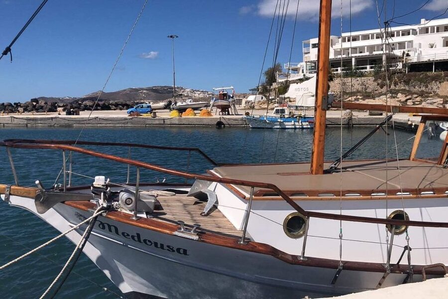 Santorini: Traditional Wooden Boat Tour with Meal and Wine - What to bring for a day that includes snorkeling and hot springs