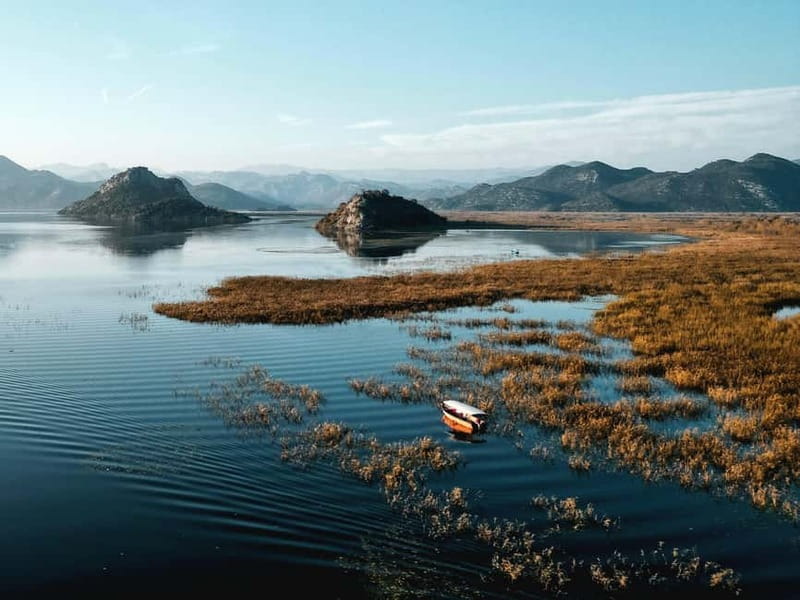 Skadar Lake: Guided Sunset Boat Tour with Wooden Boat & Wine - Gorice islands and lotus-lined channels: the lake gets narrow